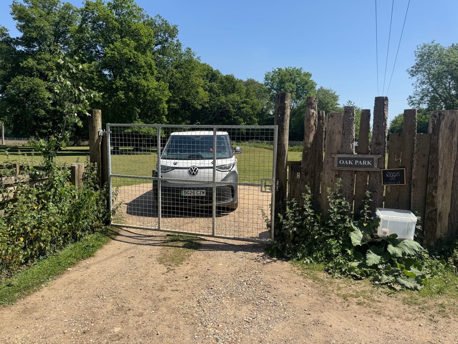 Oak Park entrance with the K9 van parked behind a closed metal gate, Oak Park sign on the right post